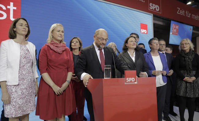 SPD party chairman and top candidate Martin Schulz addresses his supporters in the headquarters of the Social Democratic party in Berlin, Germany, Sunday, Sept. 24, 2017, after the polling stations for the German parliament elections had been closed. The sign reads : "It's Time". (AP Photo/Gero Breloer)