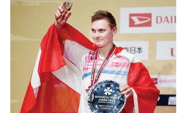 Viktor Axelsen of Denmark poses for photographers during the awards ceremony after his victory in the men’s singles final match over Lee Chong Wei of Malaysia at the Japan Open Badminton Championships in Tokyo on Sunday. (AFP)