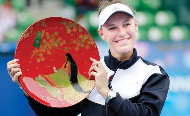 Caroline Wozniacki of Denmark poses with the winner’s plate after beating Anastasia Pavlyuchenkova of Russia at the Pan Pacific Open tennis tournament in Tokyo Sunday. (AP)