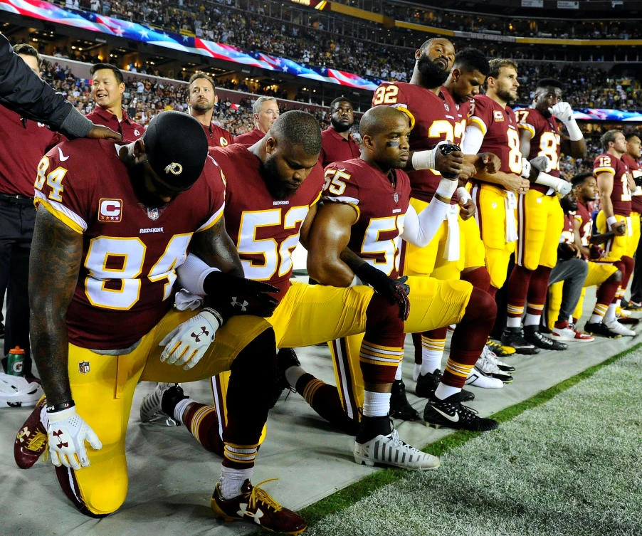 Washington Redskins tight end Niles Paul (84) and linebacker Ryan Anderson (52) and Washington Redskins linebacker Chris Carter (55) kneel with teammates during the playing of the national anthem before the game between the Washington Redskins and the Oakland Raiders at FedEx Field. (Brad Mills-USA Today Sports)