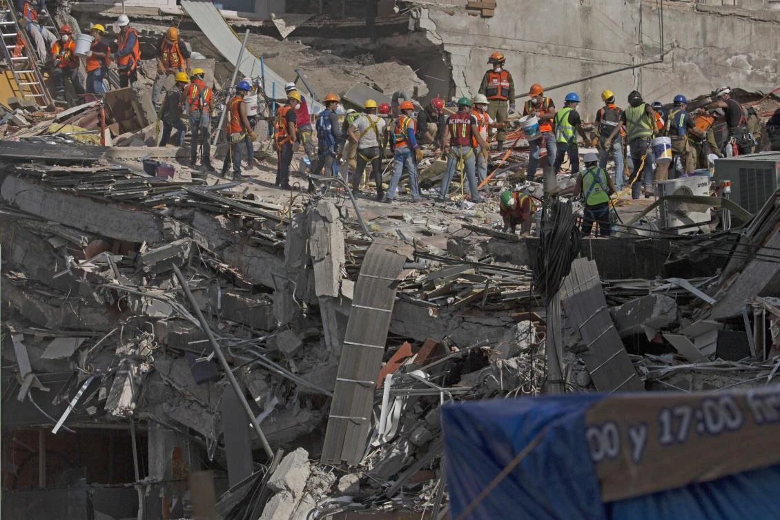 Search and rescue workers search for survivors at a felled office building brought down by a 7.1-magnitude earthquake in the Roma Norte neighborhood of Mexico City on Saturday, September 23, 2017. (File photo by AP)