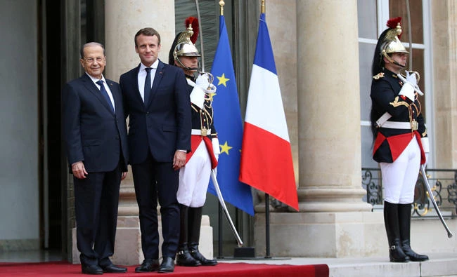 French President Emmanuel Macron welcomes Lebanon's President Michel Aoun at the Elysee Palace at a start of a state visit in Paris, France, on Monday. (Reuters)
