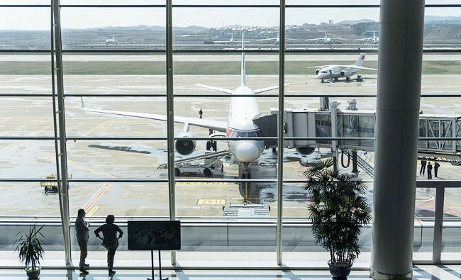 This file photo taken on April 17, 2017 shows travellers standing before an Air Koryo aircraft at Pyongyang airport. (AFP)