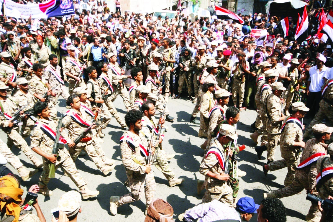 Pro-government troops parade to mark the 55th anniversary of the September 1962 revolution in the southwestern Yemeni city of Taiz on Tuesday. (Reuters)