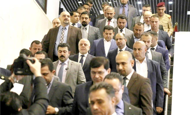 Iraqi Prime Minister Haider Al-Abadi, center, arrives for a session of the Parliament in Baghdad on Wednesday. (AP)