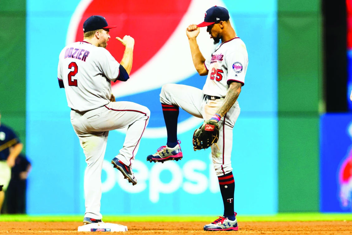 Brian Dozier (2) celebrates with Byron Buxton of the Minnesota Twins after the Twins defeated the Cleveland Indians at Progressive Field on Tuesday in Cleveland, Ohio. The Twins defeated the Indians 8-6. (AFP)