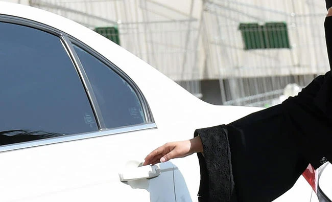 This file photo taken on October 26, 2014 shows a Saudi woman getting into a taxi at a mall in Riyadh. (AFP)