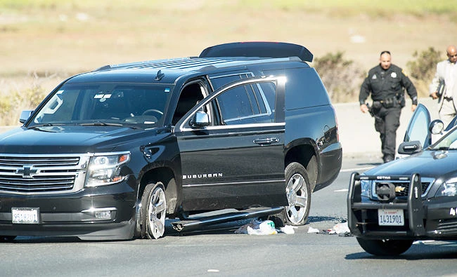 Police officers investigate the scene of a standoff with a suspect driving a sports utility vehicle on westbound Interstate 80 on Wednesday, in Emeryville, Calif. (AP)