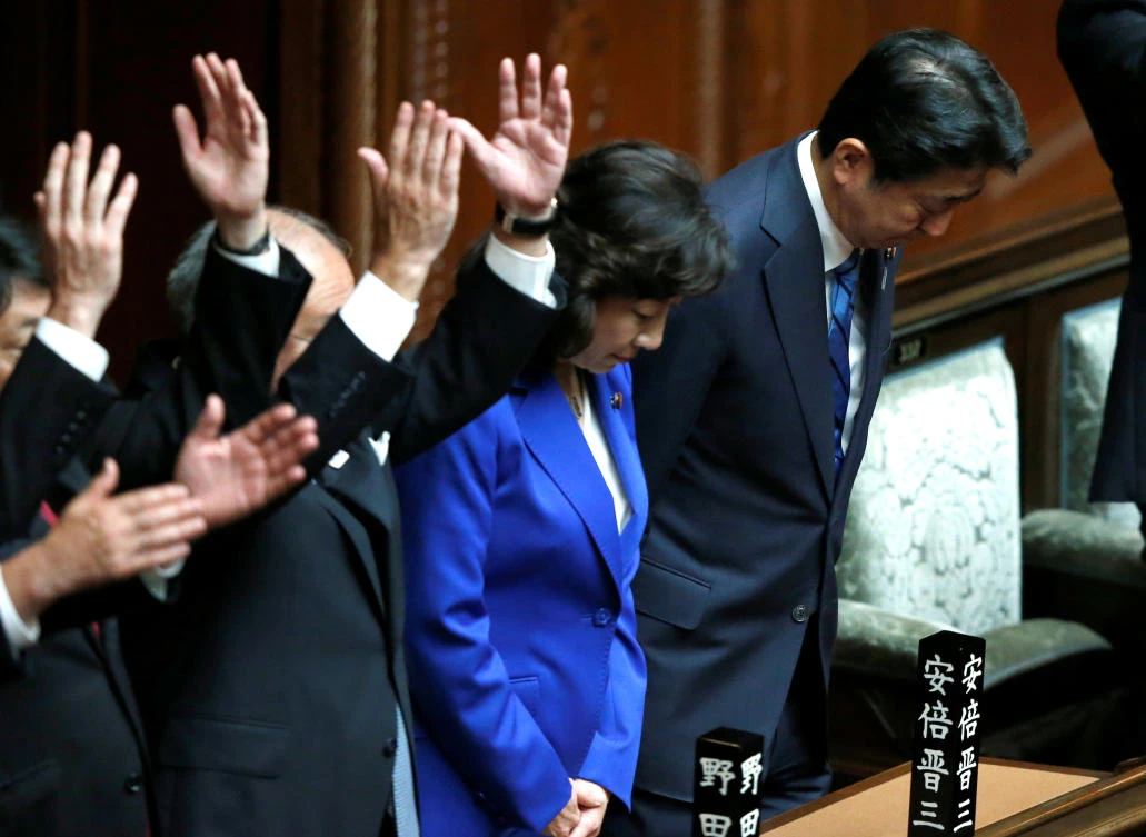 Japan’s Prime Minister Shinzo Abe, right, bows after the dissolution of lower house was announced at the parliament in Tokyo. (Reuters)