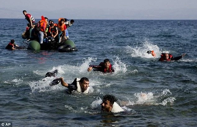 Migrants whose boat stalled at sea while crossing from Turkey to Greece swim to the shore of the island of Lesbos. (AP)