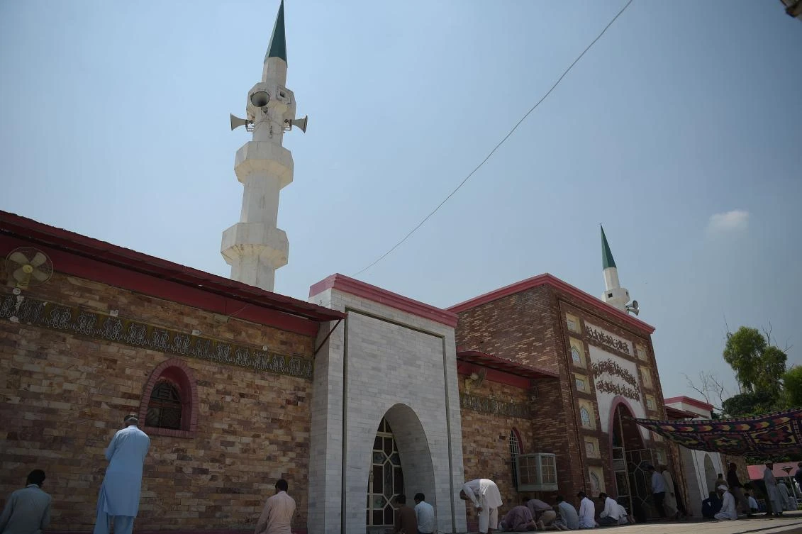 This photograph taken on July 7, 2017, shows Pakistani faithful offering Friday prayers at the Red Mosque in Islamabad commemorating the 10th anniversary of a military operation and the siege of the Red Mosque by Islamic extremists. Despite public humiliation and a stint in jail, the former leader of Pakistan's notorious Red Mosque is inspiring a new generation of extremists with his old rhetoric -- highlighting Islamabad's ambivalent attempts to bring religious hardliners to heel. (AFP)