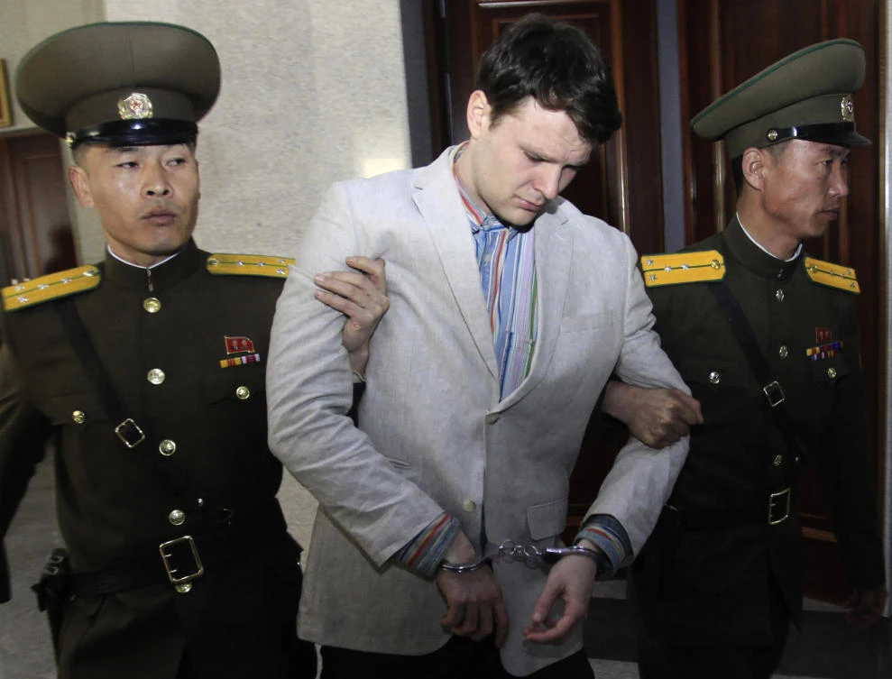 In this photo, American student Otto Warmbier, center, is escorted at the Supreme Court in Pyongyang, North Korea on March 16, 2016. (File photo by AP)