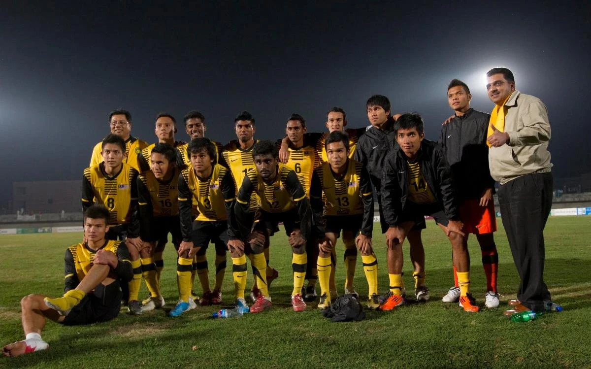 Members of Malaysia’s football team pose for the media after playing their qualifying match for the 2012 London Olympic Games against Pakistan, in Lahore on March 9, 2011. (File photo by Reuters)
