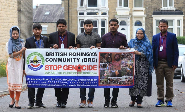 British Rohingya community President Nijam Uddin Mohammed, 2nd left, Vice President Nur Heda, 3rd left, pose with other members, Omme Kulsum, left, Samuda Harun, 2nf right, and others in Bradford, west Yorkshire on Wednesday. (AFP