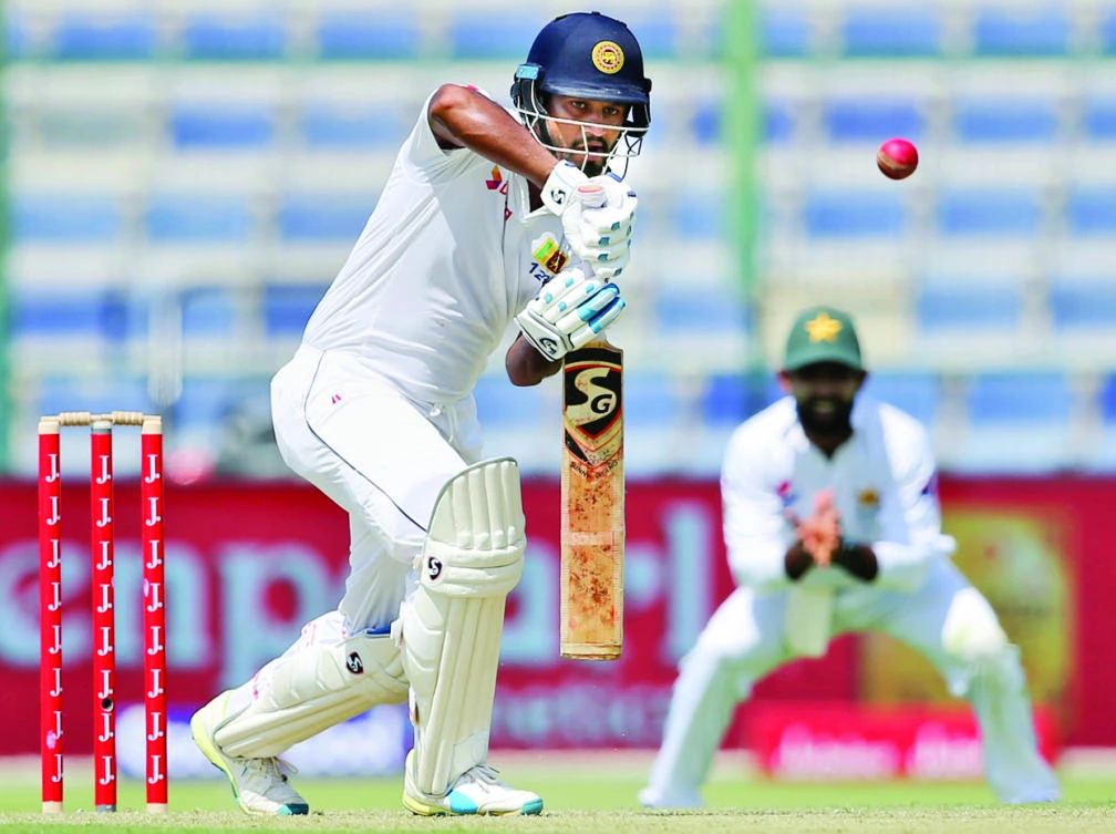 Sri Lanka’s batsman Dimuth Karunaratne plays a shot during their 1st Test cricket match against Pakistan in Abu Dhabi Thursday. (AP)