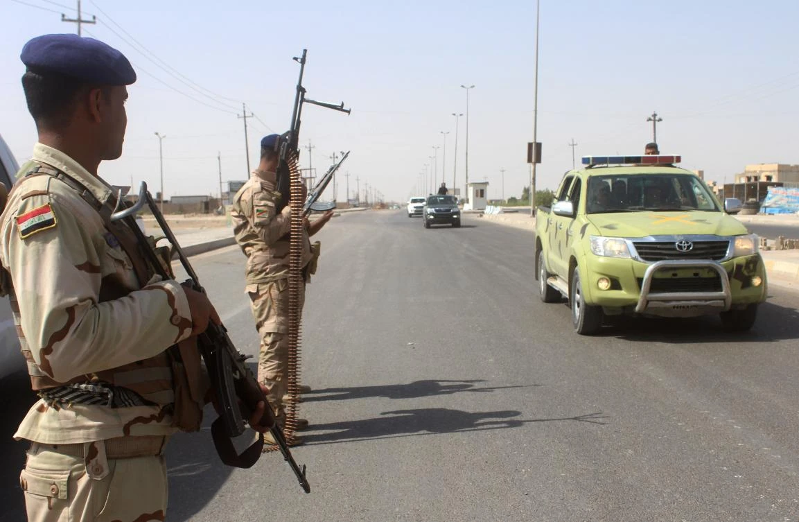 Iraqi pro-government forces patrol a road in the city of Ramadi, west of Baghdad. (AFP/Moadh Al-Dulaimi)