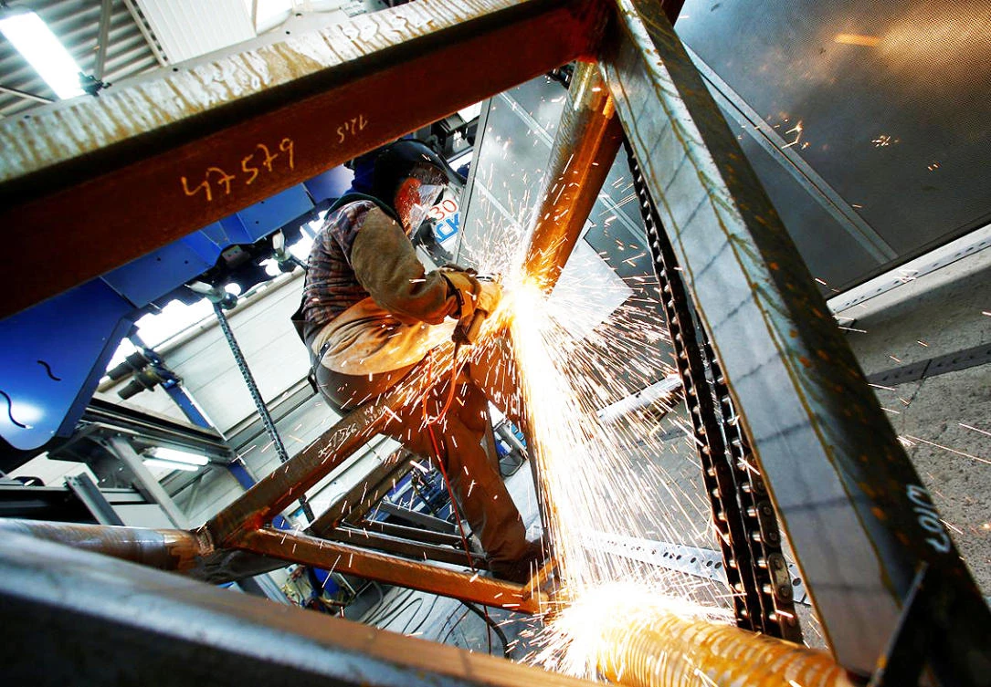 An employee works on a track of a MACK Rides rollercoaster at the production plant in Waldkirch near Freiburg, Germany.