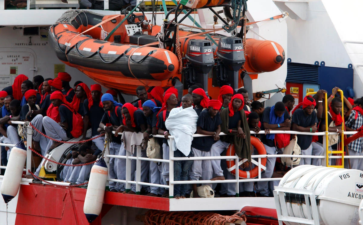 Migrants wait to disembark from a Save the Children rescue ship in the Sicilian harbour of Catania, Italy, on Thursday. (Reuters)