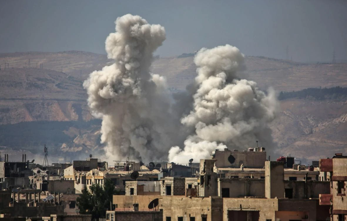 Smoke billows following bombardment on Friday in an opposition-held town, on the outskirts of Damascus, Syria. (AFP)