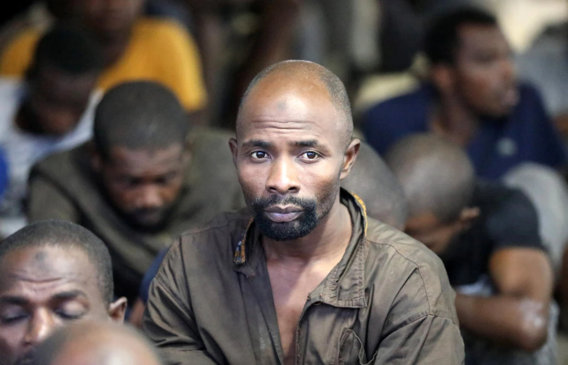 A migrant sit at a naval base after he was rescued by Libyan coastguard, in Tripoli, Libya. (Reuters)
