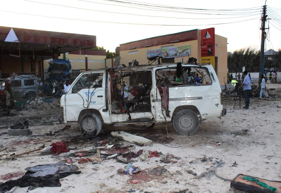 Bystanders look at the wreckage of a minibus after a car bomb exploded in the center of Mogadishu on Thursday. (AFP)