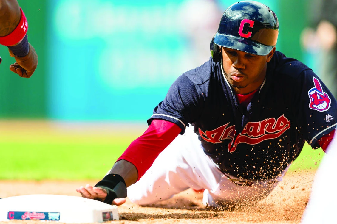 Greg Allen #53 of the Cleveland Indians dives back to first base during the seventh inning against the Minnesota Twins at Progressive Field on September in Cleveland, Ohio on Thursday. (AFP)