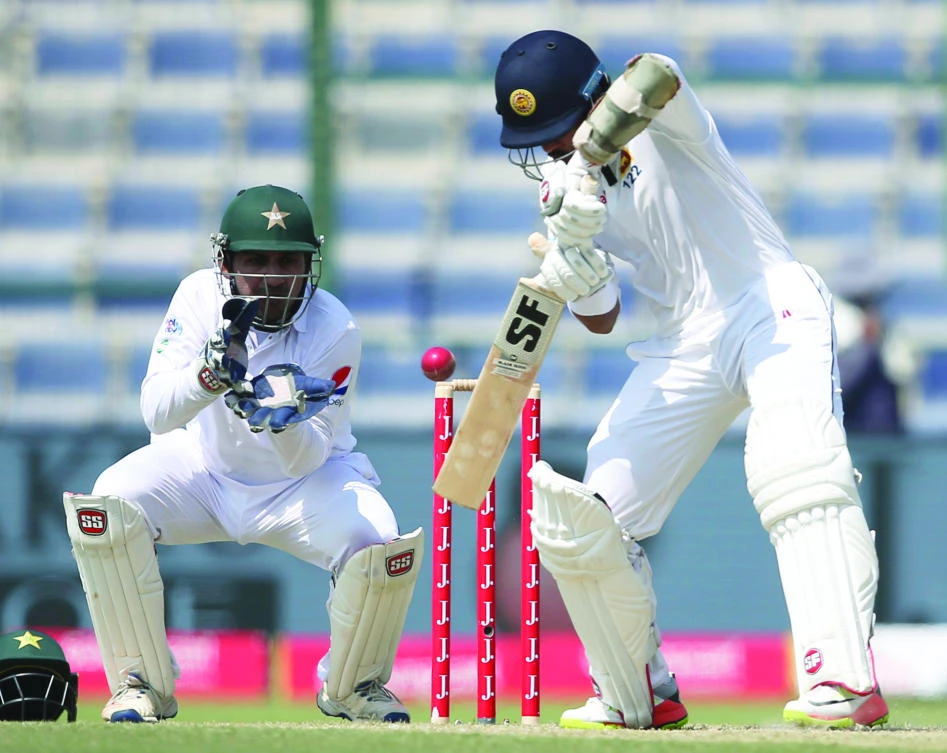 Sri Lanka’s batsman Dinesh Chandimal plays a shot during their second day of
the first Test cricket match in Abu Dhabi on Friday. (AP)