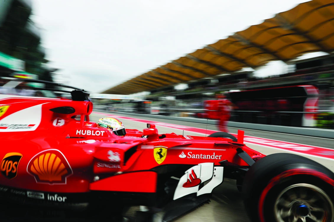 Ferrari driver Sebastian Vettel of Germany steers his car out from his team garage during
the second practice at the Sepang International Circuit for the first practice session for
the Malaysian Formula One Grand Prix in Sepang, Malaysia, on Friday. (AP)
