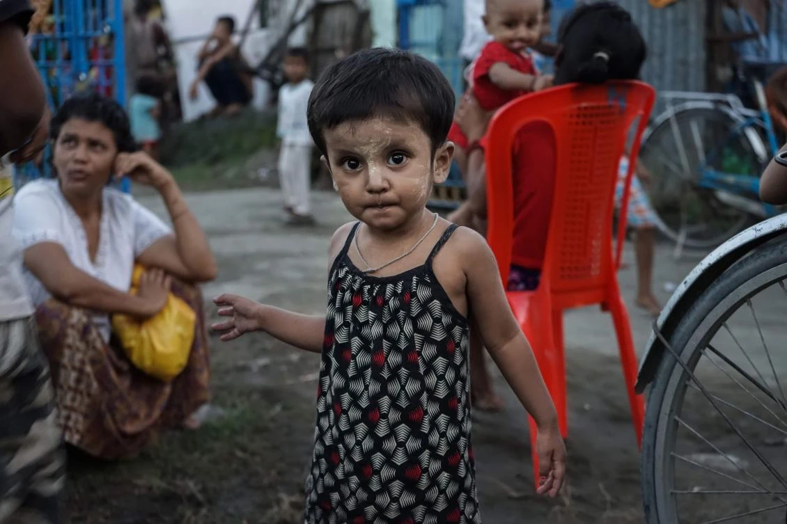 This photograph taken on September 21, 2017 shows a Hindu girl wearing traditional 'thanaka' make up stands in the yard of a IDP camp for Hindu in the Sri Sri Moha Dev Bari Hindu Temple in Sittwe, in Myanmar's Rakhine state. Thousands of Hindus have been displaced by ethnic and religious violence that has torn through Rakhine state since August 25. Hindu villagers blame Rohingya Muslims for forcing them to flee their homes and say they will not go back until their safety is assured. (AFP)