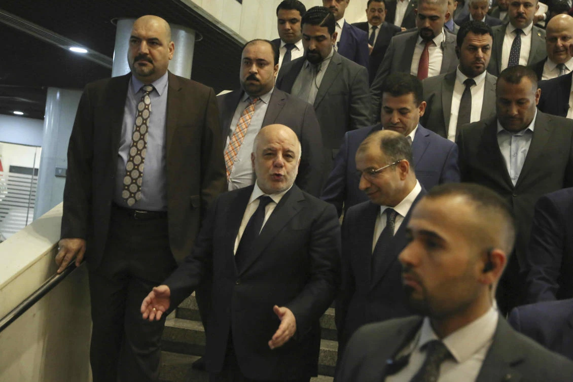 Iraqi Prime Minister Haider al-Abadi, center left, arrives for a session of the Iraqi Parliament, in Baghdad, Iraq, Wednesday, Sept. 27, 2017. Al-Abadi on Wednesday ordered the Kurdish region to hand over control of its airports to federal authorities or face a flight ban. (AP)