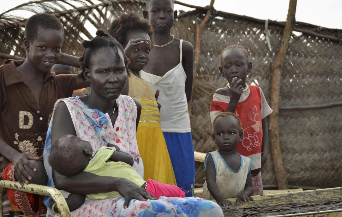 Yanut Ayuel, 2nd left, sits with her family at the displaced persons' camp where she lives and is stranded in Abayok, South Sudan Sunday, Aug. 20, 2017. South Sudan's independence from Sudan in 2011 drew thousands of people wanting to return to their hometowns in the world's newest nation, but civil war has stranded many of them for years in a border town, far from their families. (AP)