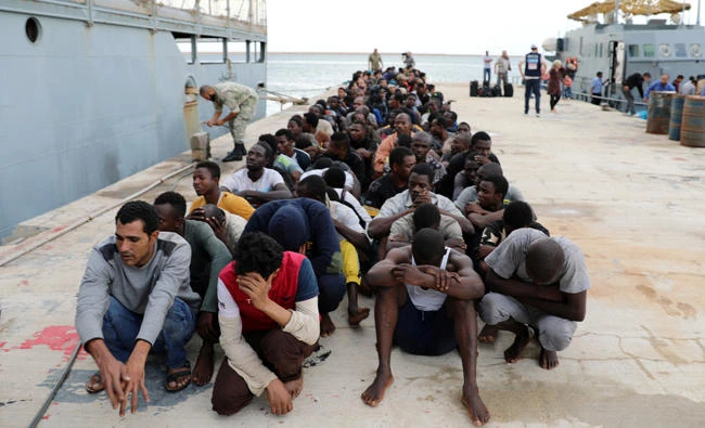 Migrants sit at a naval base after they were rescued by Libyan coastguard in Tripoli, Libya, on September 27, 2017. (Reuters)