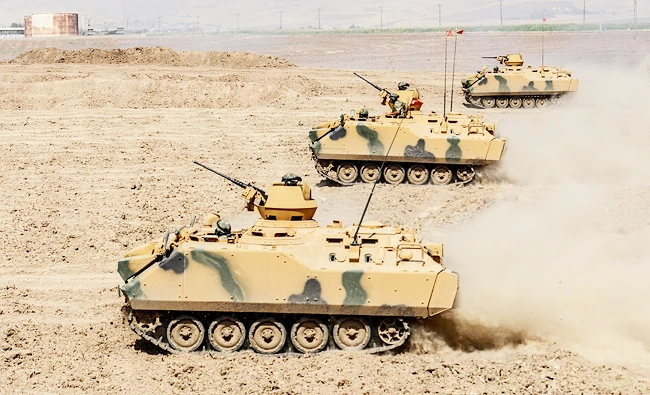 Turkish soldier ride armoured vehicles near the Habur crossing gate between Turkey and Iraq during a military drill, in this September 27, 2017 photo, in the Silopi district, southeast Turkey. (AFP)