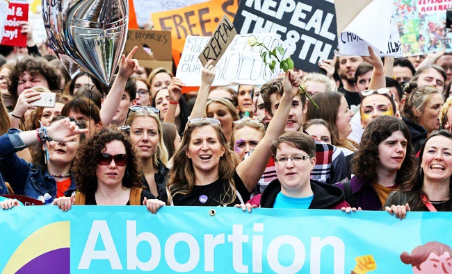 Protesters hold up placards as they take part in the March for Choice, calling for the legalising of abortion in Ireland after the referendum announcement, in Dublin on Saturday. (AFP)