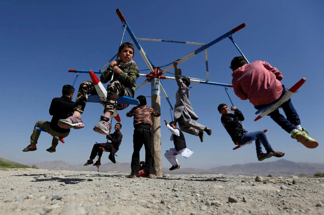 Afghan children ride on swings during the first day of Eid Al-Adha, in Kabul, Afghanistan, on September 1, 2017. (REUTERS)