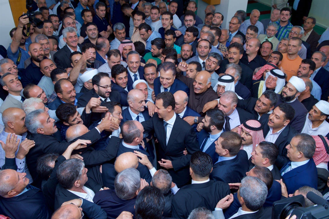 Syria’s President Bashar Assad greets his supporters during Eid Al-Adha prayers at a mosque in the town of Qara, north of Damascus, Syria, on September 1, 2017. (SANA handout via REUTERS)