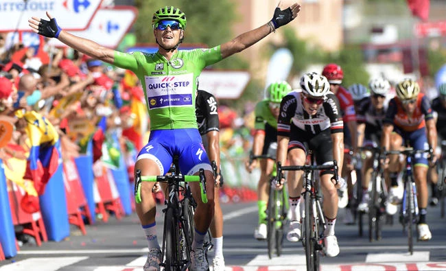 Quick-Step Floors' Italian cyclist Matteo Trentin, left, celebrates as he crosses the finish line winning the 13th stage of La Vuelta Tour of Spain on Friday. (AFP)