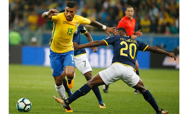 Brazil's Pualinho, left, fights for the ball with Ecuador's Marcos Caicedo during a World Cup qualifying soccer match in Porto Alegre, Brazil, Thursday. (AP)
