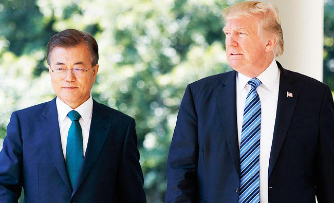 In this June 30, 2017 photo, U.S. President Donald Trump walks with South Korean President Moon Jae-in to make statements in the Rose Garden of the White House in Washington. (AP)