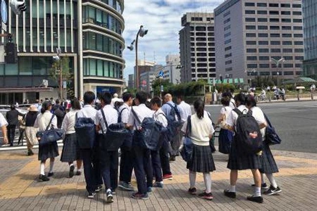 Japanese schoolchildren cross a street in Tokyo, as schools reopened Friday, September 1, 2017. (AFP)