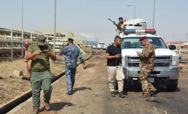 Iraqi security forces inspect the site of suicide bombings at a power plant north of Baghdad on Saturday, September 2, 2017. (AFP / Mahmud Saleh)