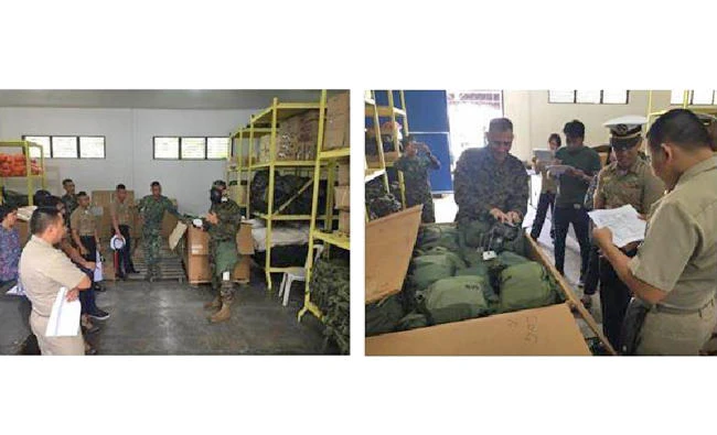 Members of the Joint US Military Assistance Group demonstrate the wear and use of M40 field protective masks at Philippine Marine headquarters in Taguig, Philippines. (US Embassy photos)