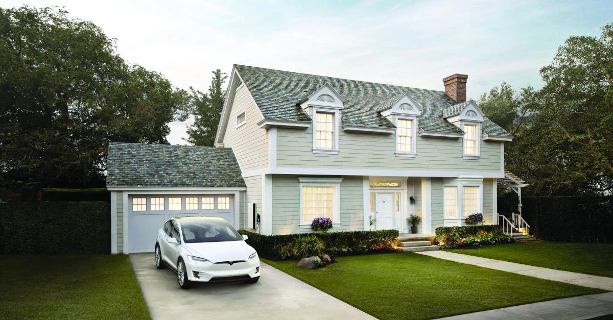 Tesla has already begun installing its solar roofs, which look like regular roofs but are made of glass tiles. (Tesla via AP)