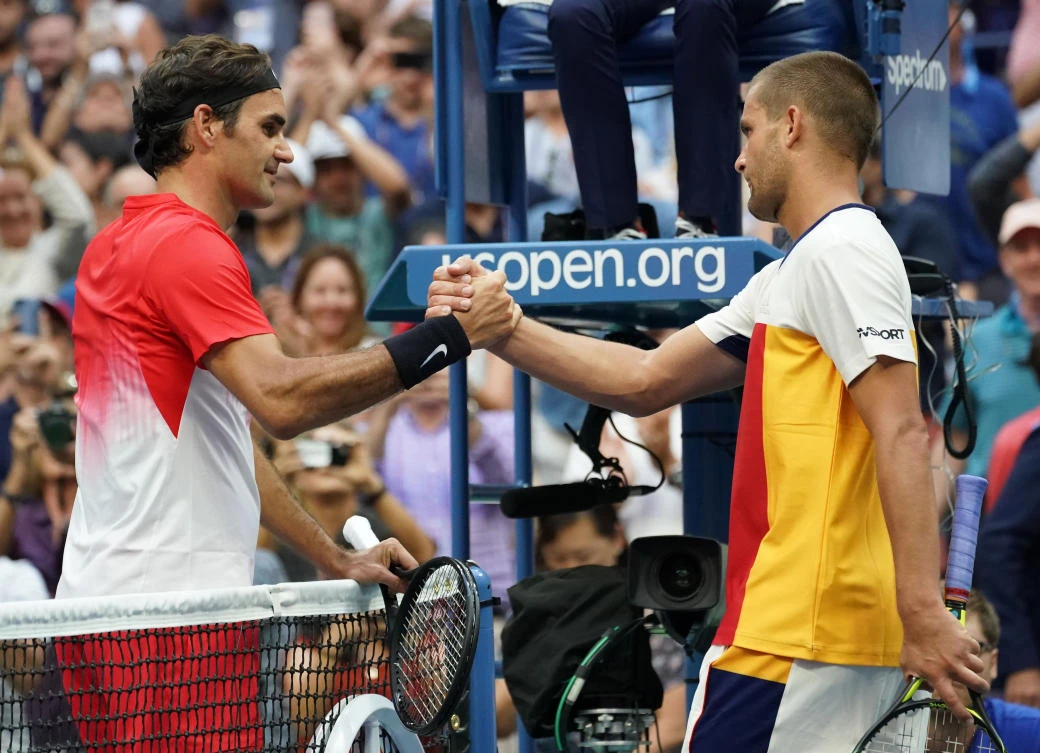 Roger Federer of Switzerland, left, reacts after beating Mikhail Youzhny of Russia in Ashe Stadium on day four at the USTA Billie Jean King National Tennis Center. Mandatory Credit: (USA TODAY Sports/Robert Deutsch)