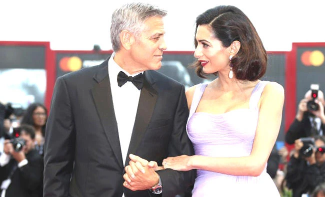 George Clooney, left, and Amal Clooney pose for photographers upon arrival at the premiere of the film ‘Suburbicon’ during the 74th edition of the Venice Film Festival in Venice, Italy. (AP)