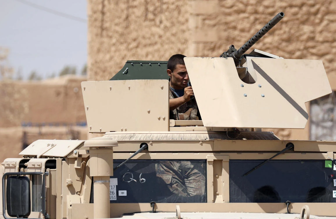 A member of Deir al-Zor military council which fights under the Syrian Democratic Forces (SDF) stands in a military tank in Deir al-Zor province, Syria August 25, 2017. (REUTERS)