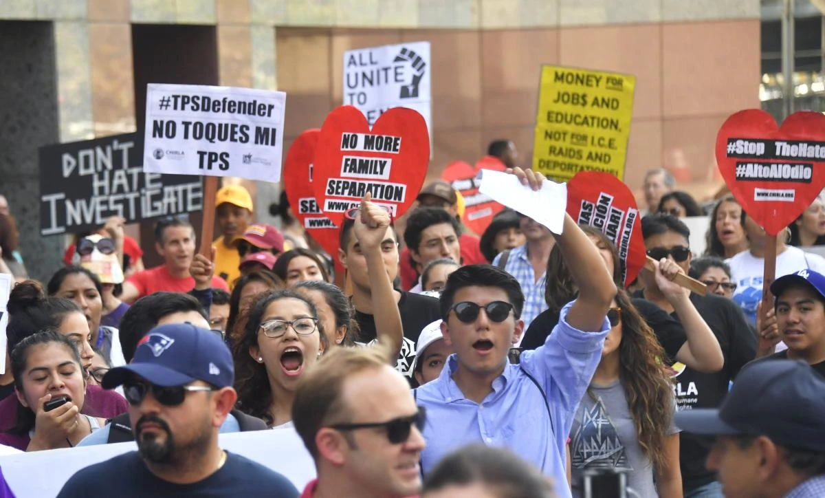 Young immigrants and supporters walk holding signs during a rally in support of Deferred Action for Childhood Arrivals (DACA) in Los Angeles, California on September 1, 2017. (AFP)