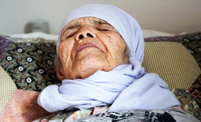 106-year old Afghan refugee Bibihal Uzbeki lies in bed in Hova, Sweden, on Sunday, and despite being severely disabled and barely able to speak, she is facing deportation from Sweden after her asylum application was rejected. (AP)