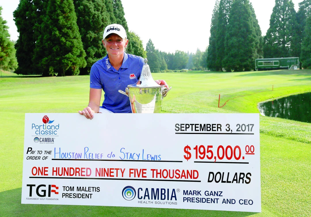 Stacy Lewis with the winner's check on the 18th green after her victory during the final round of the LPGA Cambia Portland Classic at Columbia Edgewater Country Club on Sunday in Portland, Oregon. (AFP)