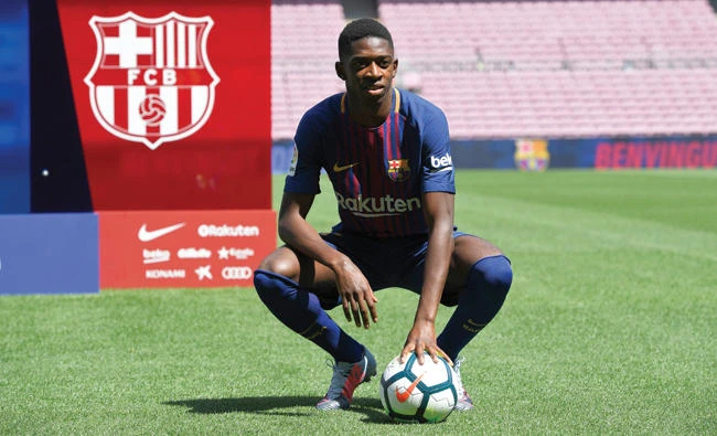 Barcelona's new player Ousmane Dembele poses with a ball at the Camp Nou stadium in Barcelona, during his official presentation by the Catalan football club, last Monday. (AFP)
